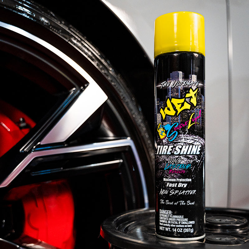 Street Legal Wet Tire Shine 14 oz can with yellow cap displayed beside a car wheel.