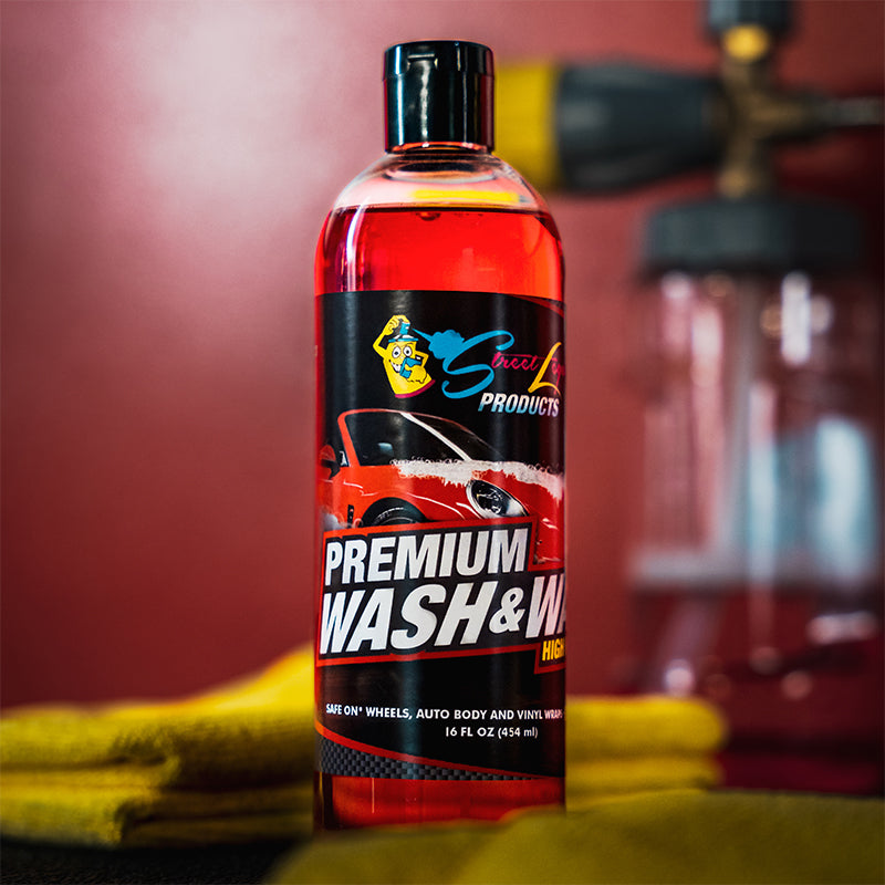 
                      
                        Street Legal Premium Wash & Wax Soap 16 oz bottle with red sports car image displayed on a counter with a yellow cloth and car cleaning tools.
                      
                    